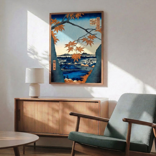 Serene framed Japanese print inspired by Hiroshige, featuring golden-orange maple leaves and branches suspended above a tranquil landscape of blue water, distant mountains, and a peaceful village.