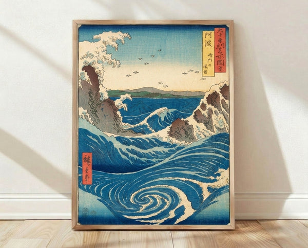 Japanese woodblock print depicting a dramatic swirling whirlpool in prussian blue and turquoise waters, with rocky outcrops and distant mountains in cream and brown tones, birds flying overhead in serene yet majestic composition.