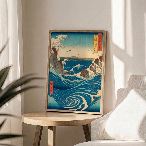 Dramatic seascape woodblock artwork depicting swirling Naruto whirlpool in richly contrasting prussian blue and cream tones, turquoise water, distant mountains, and soaring birds in majestic style.