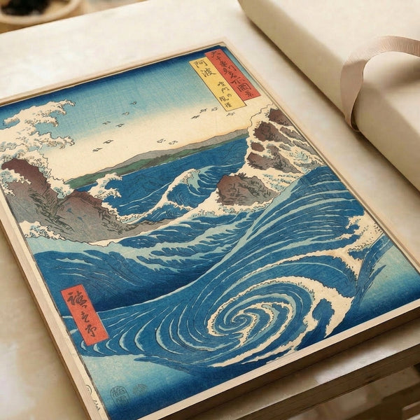 Serene yet dramatic seascape: Japanese woodblock print showing majestic whirlpool in deep blues and turquoise, cream highlights on rocks and foam, brown mountain forms, pale yellow atmospheric glow.