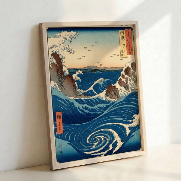 Classic Japanese woodblock landscape featuring a turbulent naruto whirlpool in rich indigo tones, dramatic rocky terrain, and birds in flight with cream and rust accents.