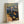 Badende poster print displaying a serene beach scene rendered in delicate watercolor with cool blue and warm ochre hues, evoking quiet reflection.