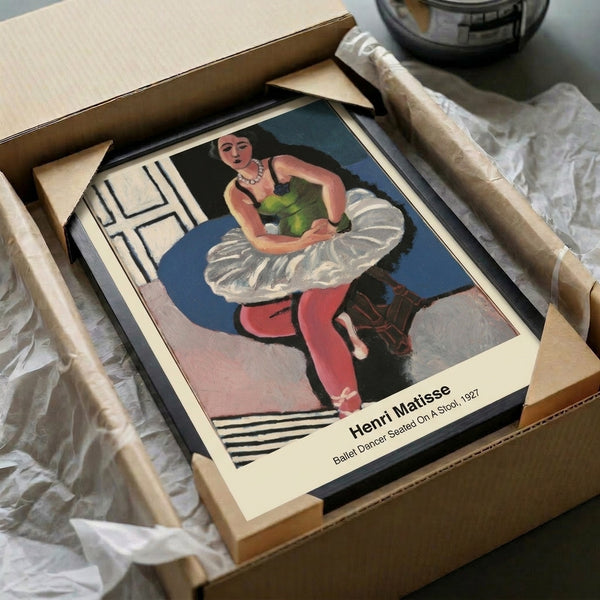 Contemporary framed print of a contemplative female dancer seated, executed in the modernist line-art aesthetic with ochre and black against white.