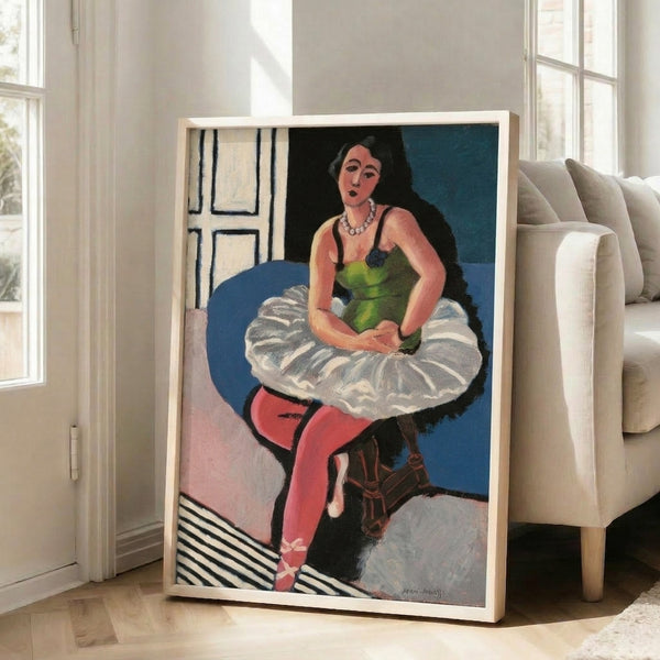 Contemporary-style framed print showing a poised dancer seated, executed in refined black line art against a warm, understated backdrop.