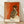 Impressionist watercolor painting of a ballet dancer with crossed arms in ochre, cream, and soft gold tones, capturing a graceful and contemplative pose.