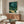 Japandi wall art showing a meditative nocturnal landscape with glowing fireflies, still water, and bamboo in soft cream, teal, and dark green hues.