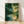 Serene Japanese woodblock-style framed poster depicting fireflies glowing above a bamboo stream at night, rendered in forest green, teal, and gold tones with an impressionist touch.