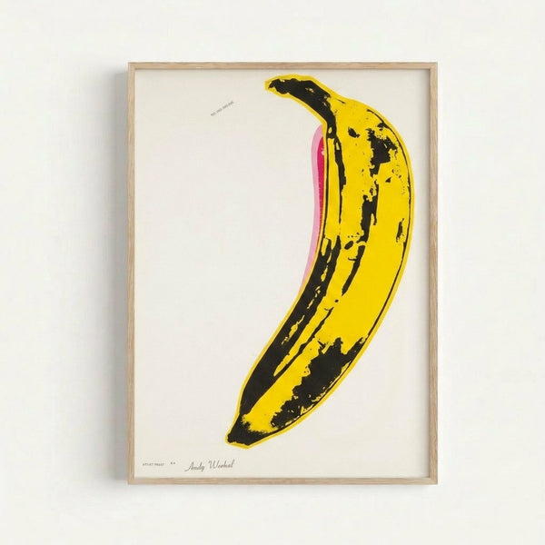 Minimalist framed art print featuring a stylized banana in bright yellow tones, rendered in classic pop art aesthetic for modern home decor.