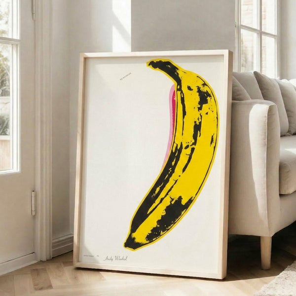 Simple yet striking banana illustration in yellow on a neutral background, executed in iconic pop art style as a modern wall print.