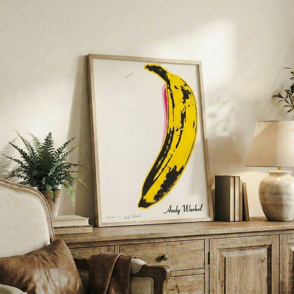 Pop art banana poster with bold lines and saturated yellow color, a recognizable contemporary art print for stylish interior spaces.
