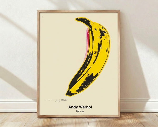Bold yellow banana on white background in pop art style, framed poster with black accents evoking Warhol's iconic modern art.