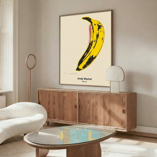 Pop art banana design in bright yellow tones with minimalist black and white composition, playful contemporary wall art.