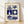 Bauhaus-style grid poster in navy blue and cream featuring minimalist icons of a cathedral, tree, guitar, sun, boat, and birds arranged in orderly sections, evoking coastal Barcelona charm.