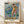Edvard Munch impressionist painting of a male swimmer in turquoise and ochre tones, framed poster on wall showing a contemplative figure in the sea.