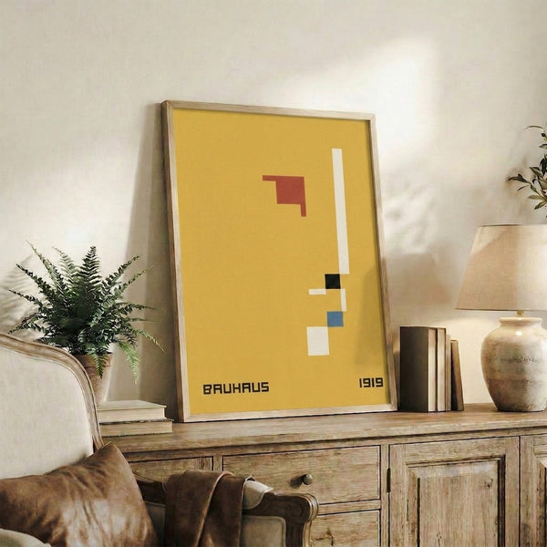 Minimalist geometric art print in the Bauhaus tradition, combining abstract shapes in a striking palette of yellow, red, cream, charcoal, and blue.