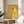 Framed constructivist composition with stark geometric abstraction in golden yellow, terracotta, cream, black, and steel blue, inspired by 1919 Bauhaus design.