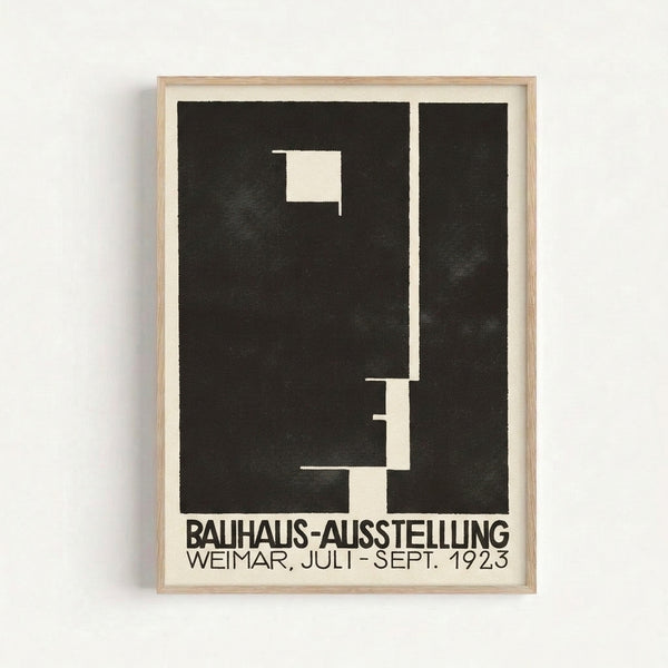 Framed geometric poster with stark black typography and abstract forms on cream background, exemplifying 1923 Bauhaus design principles.