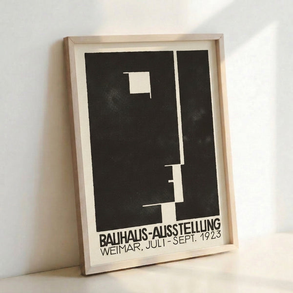 Austere minimalist art print displaying angular black geometric composition and text on off-white ground, characteristic of early Bauhaus exhibitions.