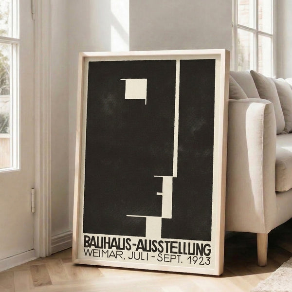 Black and cream geometric poster from the 1923 Weimar Bauhaus Ausstellung, hung as framed wall art with intellectually rigorous design.