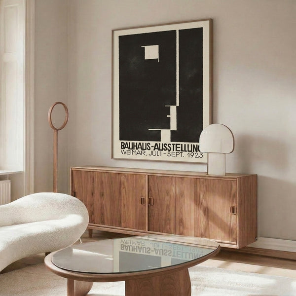 Framed modern art print showcasing bold black shapes and typography arranged on cream-colored surface in classic Bauhaus style.