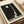 Minimalist poster art with austere black geometric forms and institutional lettering on cream background, evoking 1920s avant-garde sensibility.