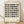 Bauhaus geometric screenprint in cream and charcoal featuring circles and rectangles arranged in a structured grid composition.