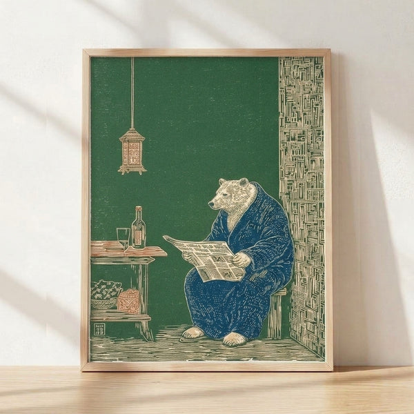 Framed Japanese woodblock-style poster of a contemplative bear in a kimono seated at a table with a newspaper, glass, and bottle, rendered in forest green, cream, and navy blue tones.