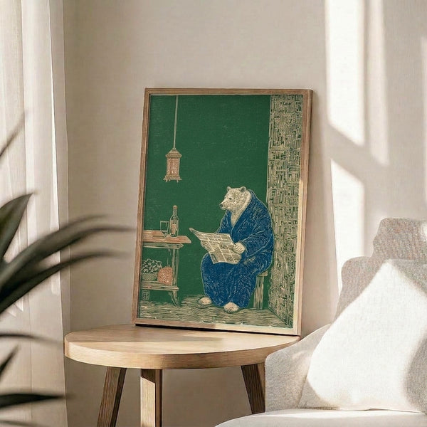 Framed poster featuring a serene bear in traditional Japanese attire absorbed in reading a newspaper at a table with a lantern and bookshelf backdrop, in muted woodland and navy tones.
