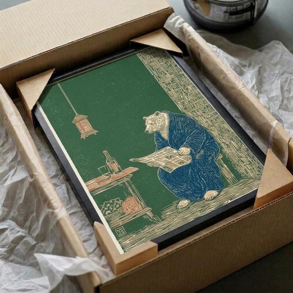 Whimsical Japanese-inspired woodblock art print of a bear in a kimono enjoying a contemplative moment with a newspaper and refreshments, framed wall art in forest green and cream palette.