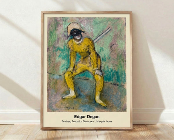Framed Impressionist painting of a ballet dancer in a yellow costume adjusting her skirt in a rehearsal room mirror, rendered in soft yellows, pale pinks, and muted grays.