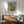 Classic Impressionist composition featuring a graceful ballet performer in soft yellow and pink hues, pausing thoughtfully in a mirrored rehearsal room.