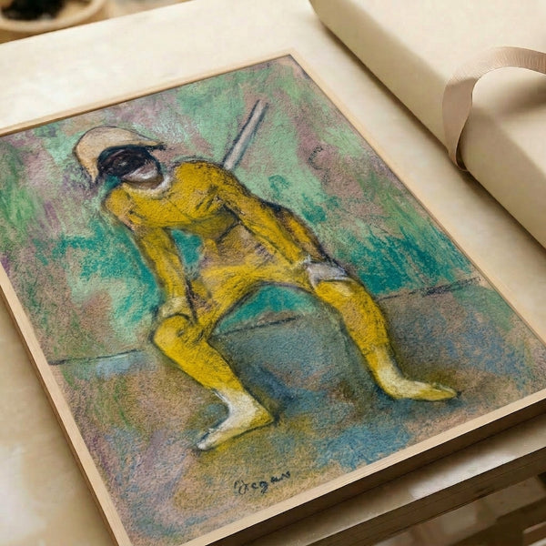 Framed art print of Degas' L'Arlequin Jaune depicting a dancer in distinctive yellow harlequin dress, with impressionistic style and warm, subdued coloring throughout.