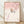 Serene Japanese woodblock-style art print depicting a bird perched on delicate cherry blossom branches in soft pink and cream tones, framed on a wall.
