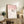 Minimalist Japanese wall art print portraying a bird amid delicate cherry blossoms in pale pink and cream, evoking serene contemplative mood.
