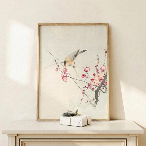 Japanese-inspired watercolor print of a bird resting on a cherry blossom branch, composed in gentle creams and pale greens with touches of soft pink and gray.