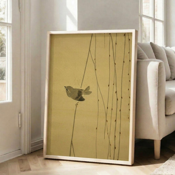 Wabi-sabi inspired framed print of a bird on drooping willow branches, rendered in delicate lines with a palette of cream, brown, and sage for tranquil decor.