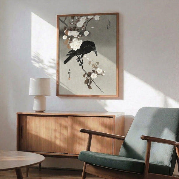 Framed poster art in Japandi style showing a crow perched on flowering branches with subtle brown and cream botanical details against soft background tones.