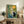 Wabi-sabi style poster showcasing a meditative scene of a black cat among traditional lantern, bamboo, and botanical elements in soft slate blue, yellow, and cream tones.