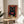 Sophisticated pop art framed print of a black cat with an ornate cocktail, pomegranate motifs, and florals in a luxurious palette of blacks, reds, and golden tones.