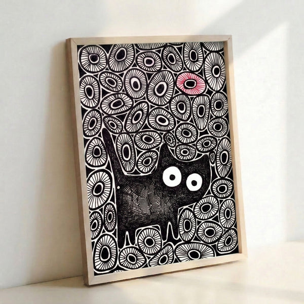 Framed art print displaying a stylized black cat amid scattered red and white eyes in bold minimalist line work, evoking quirky and mysterious charm.