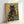 Serene art nouveau illustration of a black cat gazing through a lush wildflower garden filled with daisies and gerberas in warm, earthy color palette.