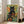 Black cat framed poster showcasing a boho-inspired garden scene with golden and orange wildflowers, leaves, and dreamy botanical details in cream and forest green.
