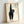 Framed folk art poster of a playful black cat in classic Japanese Showa style, combining woodblock printmaking with whimsical charm.