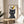 Minimalist black cat and yellow bird poster rendered in simple elegant lines on cream, conveying quirky charm and gentle contemplation.