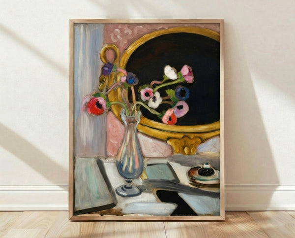 Framed poster of Black Mirror Anemones featuring bold blue and white flowers in a vase, inspired by modernist floral painting, displayed on a wall.