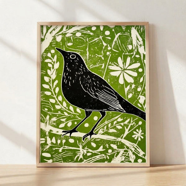 Framed folk art print featuring a blackbird perched among olive green branches with delicate line work on cream background, evoking vintage botanical imagery with a calm, naturalistic mood.