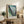 Framed modern art print displaying abstract petals and organic shapes in soothing green and blue hues with cream undertones, conveying contemplative depth.