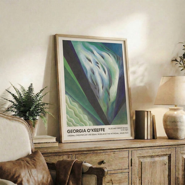 Framed modern art print displaying abstract petals and organic shapes in soothing green and blue hues with cream undertones, conveying contemplative depth.