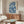 Contemplative Asian cultural art print displaying traditional kimono motifs with birds and flowers in prussian blue, cream, and pale grey on wall.