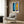 Modern minimalist poster featuring vibrant blue cut-out forms on a soft cream backdrop, hung on a wall.